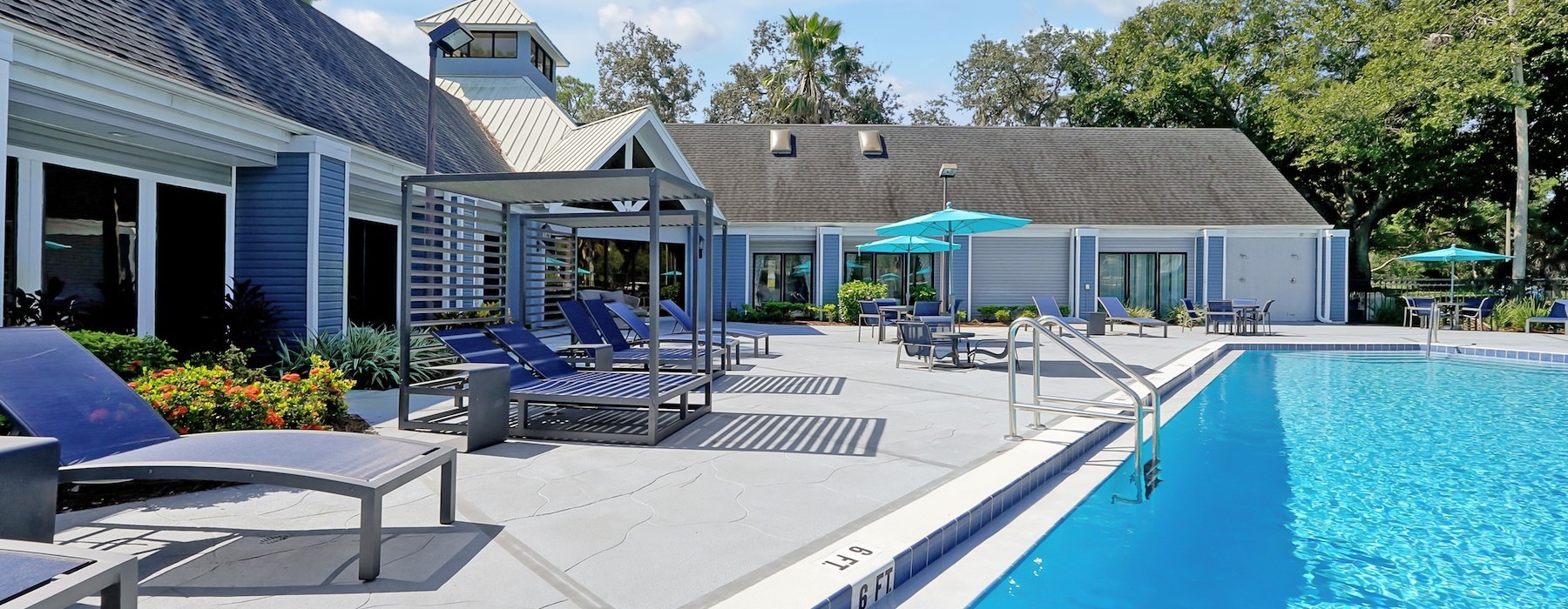 a pool with chairs in a courtyard