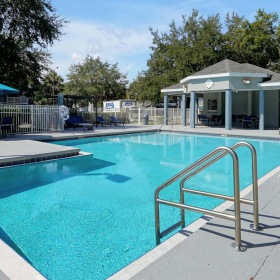 a swimming pool with a metal railing