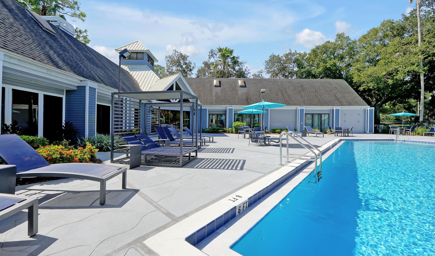 a swimming pool with a house in the background