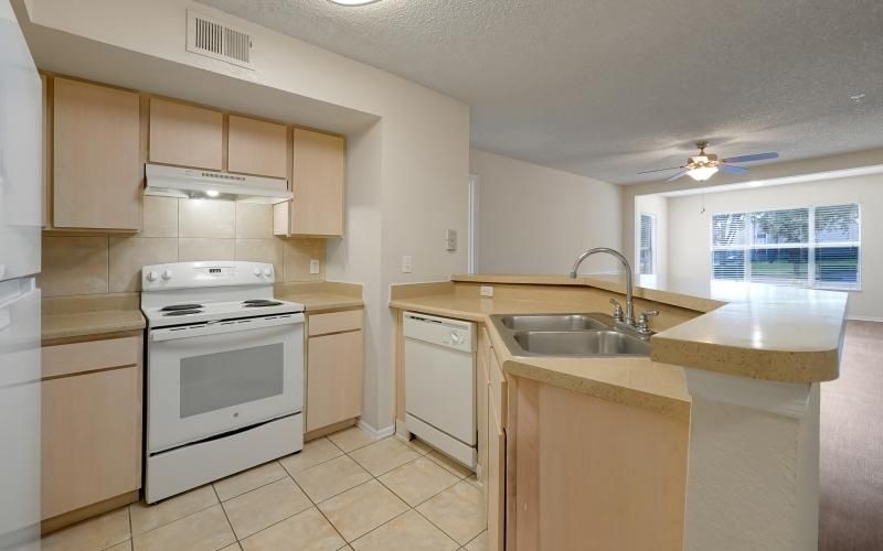 a kitchen with wood cabinets