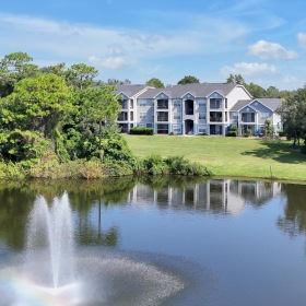 a house on a hill by a lake